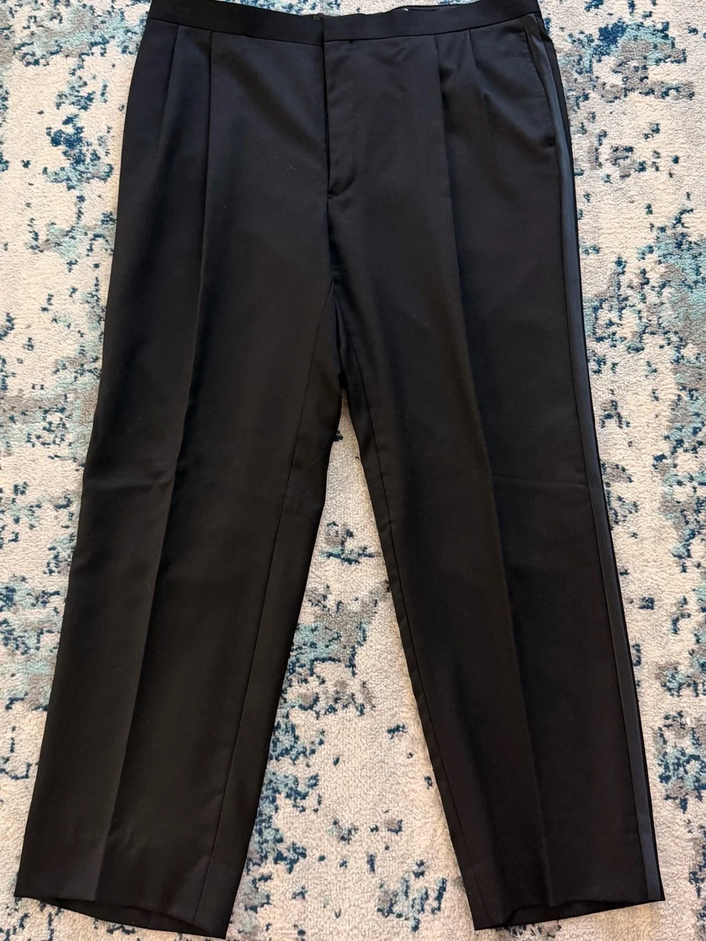 black Versini tuxedo jacket with a single-button closure and satin notch lapels.